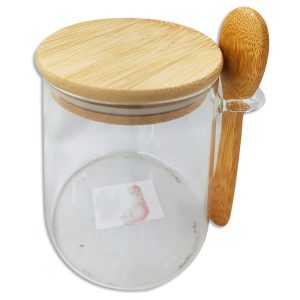 Frasco de vidrio con cuchara y tapa de madera